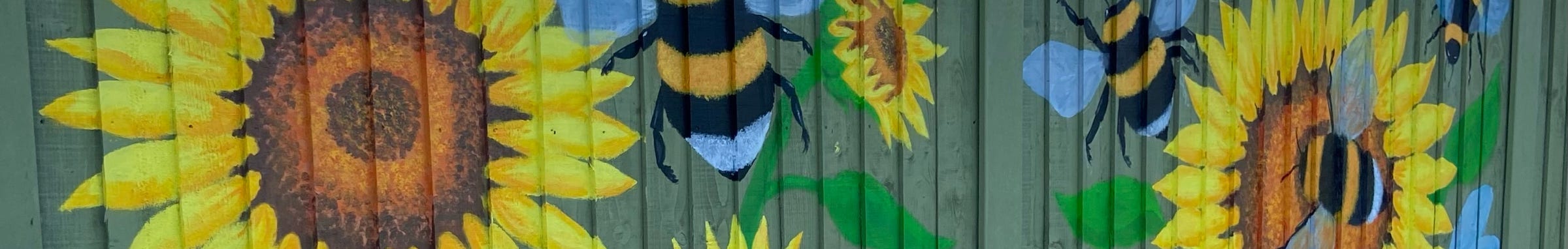 Bumble bees and Sunflowers painted on a fence
